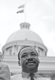 King gazes out at the crowd then prepares his speech, Montgomery,  Alabama.  1965