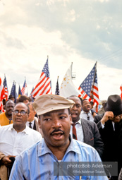 Braving the rain and singing, Martin Luther King leads the Selma to Montgomery march as it approaches it's finale in Montgomery, Alabama. 1965