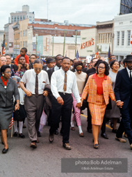 Leading a throng of 25,000 marchers, King enters the downtown at the end of the Selma to Montgomery march, Montgomery, Alabama.  1965
