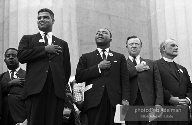 Leaders including the Reverend Ralph Abernathy (far left) and National Urban League Director Whitney Young Jr. (left) join King to pledge allegiance at the beginning of the ceremony at the Lincoln Memorial, Washington,  1963
