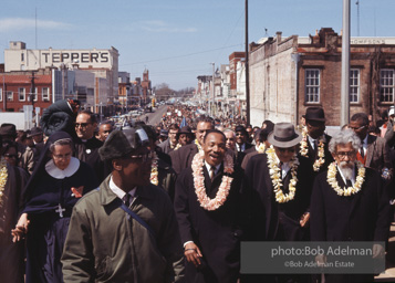 Crossing over: King leads the Montgomery-bound marchers over the Edmund Pettus Bridge, which was already famous for shocking scenes of police brutality,   Selma,  Alabama.  1965