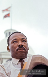 King gazes out at the crowd then prepares his speech, Montgomery,  Alabama.  1965