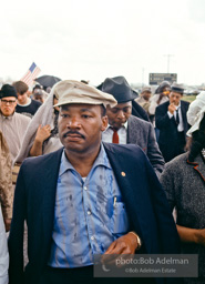 Braving the rain, Martin Luther King leads the Selma to Montgomery march as it approaches it's finale in Montgomery, Alabama. 1965