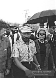 Braving the rain, Martin Luther King leads the Selma to Montgomery march as it approaches it's finale in Montgomery, Alabama. 1965