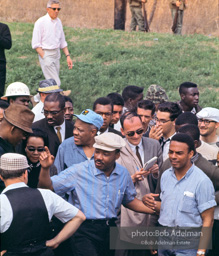 Braving the rain, Martin Luther King leads the Selma to Montgomery march as it approaches it's finale in Montgomery, Alabama. 1965