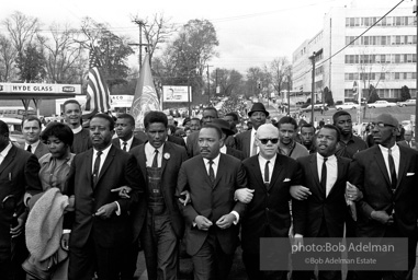 Dr. King leads a protest march around the state capital in Montgomery Alabama protesting the treatment of black demonstrators and voter applicants in Selma, Alabama prior to the Selma to Montgomery march. Montgomery, Alabama. 1965.