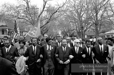 Dr. King leads a protest march around the state capital in Montgomery Alabama protesting the treatment of black demonstrators and voter applicants in Selma, Alabama prior to the Selma to Montgomery march. Montgomery, Alabama. 1965.