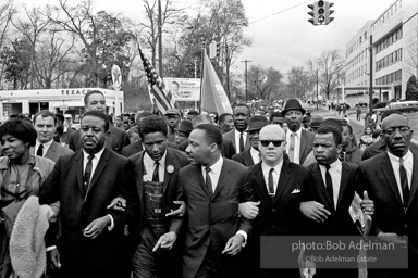 Dr. King leads a protest march around the state capital in Montgomery Alabama protesting the treatment of black demonstrators and voter applicants in Selma, Alabama prior to the Selma to Montgomery march. Montgomery, Alabama. 1965.