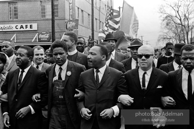 Dr. King leads a protest march around the state capital in Montgomery Alabama protesting the treatment of black demonstrators and voter applicants in Selma, Alabama prior to the Selma to Montgomery march. Montgomery, Alabama. 1965.