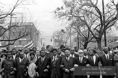 Dr. King leads a protest march around the state capital in Montgomery Alabama protesting the treatment of black demonstrators and voter applicants in Selma, Alabama prior to the Selma to Montgomery march. Montgomery, Alabama. 1965.