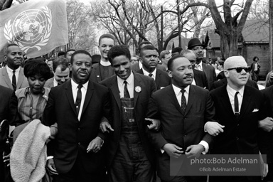 Dr. King leads a protest march around the state capital in Montgomery Alabama protesting the treatment of black demonstrators and voter applicants in Selma, Alabama prior to the Selma to Montgomery march. Montgomery, Alabama. 1965.