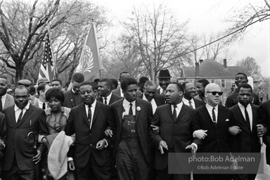 Dr. King leads a protest march around the state capital in Montgomery Alabama protesting the treatment of black demonstrators and voter applicants in Selma, Alabama prior to the Selma to Montgomery march. Montgomery, Alabama. 1965.