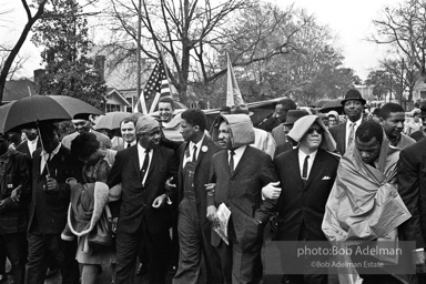 Dr. King leads a protest march around the state capital in Montgomery Alabama protesting the treatment of black demonstrators and voter applicants in Selma, Alabama prior to the Selma to Montgomery march. Montgomery, Alabama. 1965.