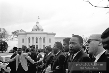 Dr. King leads a protest march around the state capital in Montgomery Alabama protesting the treatment of black demonstrators and voter applicants in Selma, Alabama prior to the Selma to Montgomery march. Montgomery, Alabama. 1965.