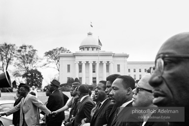 Dr. King leads a protest march around the state capital in Montgomery Alabama protesting the treatment of black demonstrators and voter applicants in Selma, Alabama prior to the Selma to Montgomery march. Montgomery, Alabama. 1965.