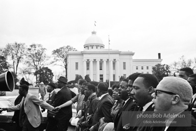 Dr. King leads a protest march around the state capital in Montgomery Alabama protesting the treatment of black demonstrators and voter applicants in Selma, Alabama prior to the Selma to Montgomery march. Montgomery, Alabama. 1965.