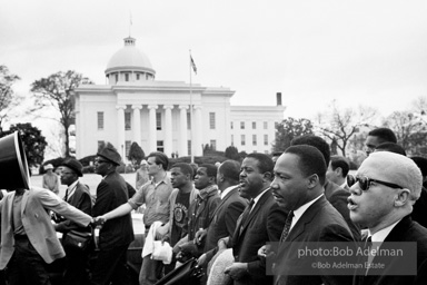 Dr. King leads a protest march around the state capital in Montgomery Alabama protesting the treatment of black demonstrators and voter applicants in Selma, Alabama prior to the Selma to Montgomery march. Montgomery, Alabama. 1965.