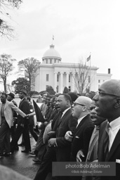 Dr. King leads a protest march around the state capital in Montgomery Alabama protesting the treatment of black demonstrators and voter applicants in Selma, Alabama prior to the Selma to Montgomery march. Montgomery, Alabama. 1965.