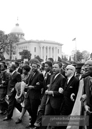 Dr. King leads a protest march around the state capital in Montgomery Alabama protesting the treatment of black demonstrators and voter applicants in Selma, Alabama prior to the Selma to Montgomery march. Montgomery, Alabama. 1965.