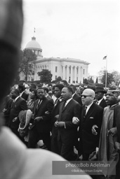 Dr. King leads a protest march around the state capital in Montgomery Alabama protesting the treatment of black demonstrators and voter applicants in Selma, Alabama prior to the Selma to Montgomery march. Montgomery, Alabama. 1965.