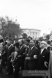 Dr. King leads a protest march around the state capital in Montgomery Alabama protesting the treatment of black demonstrators and voter applicants in Selma, Alabama prior to the Selma to Montgomery march. Montgomery, Alabama. 1965.