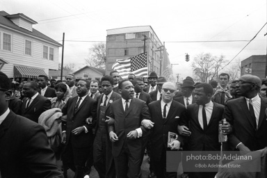 Dr. King leads a protest march around the state capital in Montgomery Alabama protesting the treatment of black demonstrators and voter applicants in Selma, Alabama prior to the Selma to Montgomery march. Montgomery, Alabama. 1965.