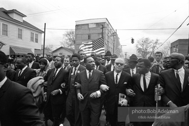 Dr. King leads a protest march around the state capital in Montgomery Alabama protesting the treatment of black demonstrators and voter applicants in Selma, Alabama prior to the Selma to Montgomery march. Montgomery, Alabama. 1965.