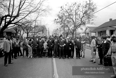 Dr. King leads a protest march around the state capital in Montgomery Alabama protesting the treatment of black demonstrators and voter applicants in Selma, Alabama prior to the Selma to Montgomery march. Montgomery, Alabama. 1965.