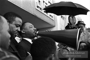 Martin Luther King speaking in front of Selma city hall protesting the denial of the right to vote to black citizens of Selma, Alabama. 1965