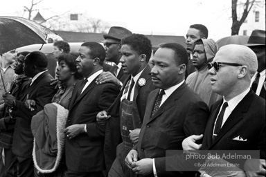 Dr. King leads a protest march around the state capital in Montgomery Alabama protesting the treatment of black demonstrators and voter applicants in Selma, Alabama prior to the Selma to Montgomery march. Montgomery, Alabama. 1965.