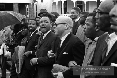 Dr. King leads a protest march around the state capital in Montgomery Alabama protesting the treatment of black demonstrators and voter applicants in Selma, Alabama prior to the Selma to Montgomery march. Montgomery, Alabama. 1965.