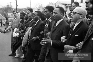 Dr. King leads a protest march around the state capital in Montgomery Alabama protesting the treatment of black demonstrators and voter applicants in Selma, Alabama prior to the Selma to Montgomery march. Montgomery, Alabama. 1965.