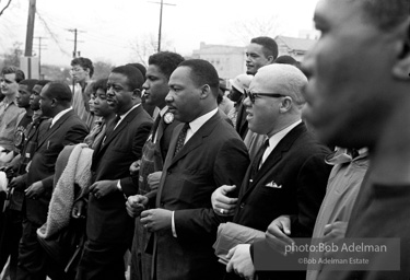 Dr. King leads a protest march around the state capital in Montgomery Alabama protesting the treatment of black demonstrators and voter applicants in Selma, Alabama prior to the Selma to Montgomery march. Montgomery, Alabama. 1965.