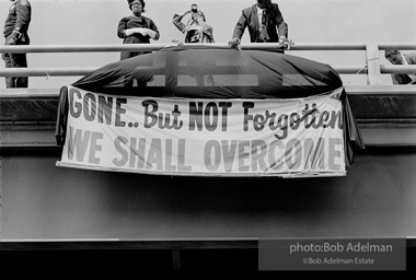 Sign at overpass during funeral procession.Martin Luther King funeral. Atlanta, GA. 1968