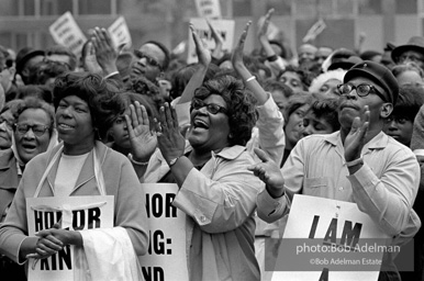 At the memorial just after Martin Luther King's asassination, mourners gather downtown , Some display picket signs 