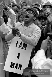 At the memorial just after Martin Luther King's asassination, mourners gather downtown , Some display picket signs 