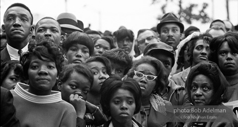 At the memorial just after Martin Luther King's asassination, mourners gather downtown , Some display picket signs 