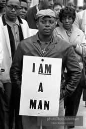 At the memorial just after Martin Luther King's asassination, mourners gather downtown , Some display picket signs 