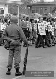 At the memorial just after Martin Luther King's asassination, mourners gather downtown , Some display picket signs 