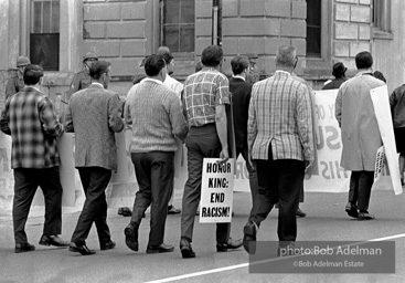 At the memorial just after Martin Luther King's asassination, mourners gather downtown , Some display picket signs 