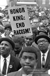 At the memorial just after Martin Luther King's asassination, mourners gather downtown , Some display picket signs 