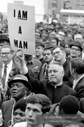 At the memorial just after Martin Luther King's asassination, mourners gather downtown , Some display picket signs 