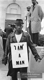 At the memorial just after Martin Luther King's asassination, mourners gather downtown , Some display picket signs 