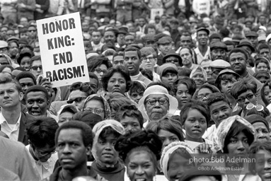 At the memorial just after Martin Luther King's asassination, mourners gather downtown , Some display picket signs 