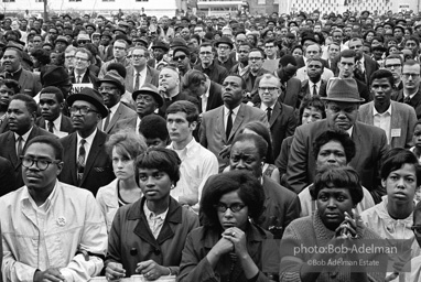 At the memorial just after Martin Luther King's asassination, mourners gather downtown , Some display picket signs 