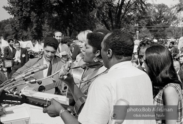 Odetta, Peter, Paul, and Mary, Joan Baez sing for the crowd assembling at the base of the Washington Monument. August 28, 1963.