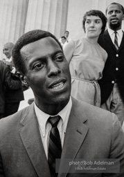Leon Bibb, entertainer, actor and singer, listens to the procedings on the steps of the Lincoln Memorial. Later he was blacklisted for his left wing sympathies and moved to Canada. He elevated many Black spirituals to art songs.