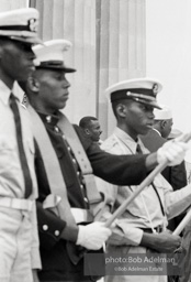 Reverand Shuttlesworth, Leader of the protest in Birmingham addresses the Marchers atop the steps of the Lincoln Memorial. He is seen through a military honor guard. Washington D.C. August 28, 1963