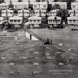 1968. Queens, New York. Warehouse next to new housing development. East Jamaica between Hollis and St. Albans. Jamaica, Queens, N.Y. 1968