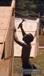 Poor Peoples march protestor finishes work on an A-frame dwelling at 